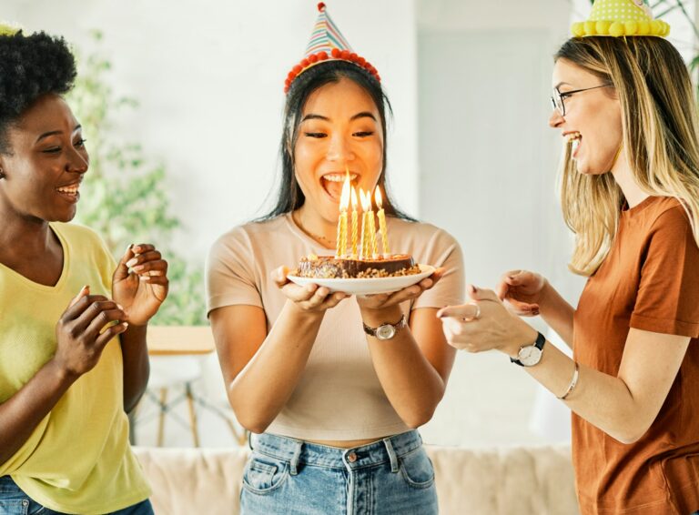 birthday celebration party cake happy candle blowing friendship fun friend woman home smiling